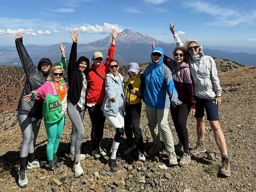 Retreat participants on a slope facing Mount Shasta